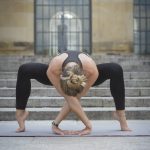 Young woman practicing yoga in the city